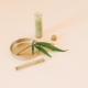A cannabis leaf with herbal extracts in a glass vial, representing natural healthcare remedies.