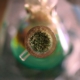 A detailed image of ground cannabis packed in a glass water pipe, highlighting its intricate texture.