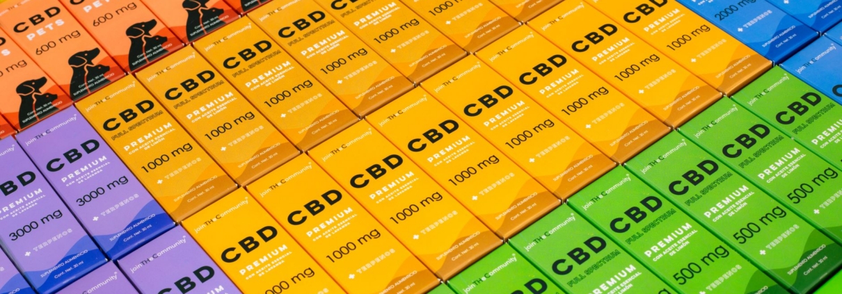 A vibrant array of CBD product boxes in various colors, photographed in Mexico City.