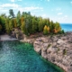 Breathtaking aerial shot of rocky coastline and forest at Presque Isle Park, Marquette, MI.