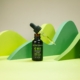 CBD oil bottles with varying dosages in a creative green backdrop, showcasing premium product packaging.