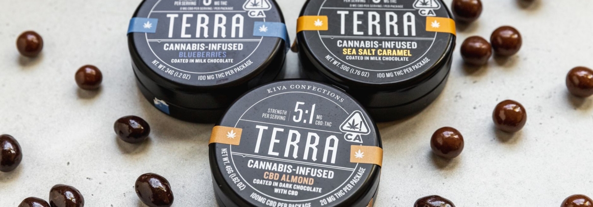 Close-up of cannabis-infused chocolate edibles in tin containers, creatively scattered.