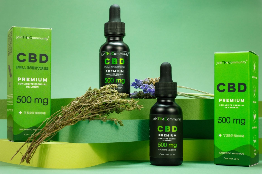Explore CBD oil and boxes styled with lavender on a green background, promoting relaxation.